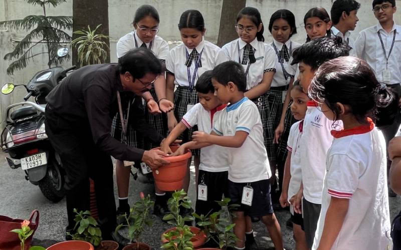 Primary students presenting Green Plants to teachers on Guru Purnima